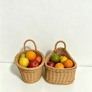 Close-up of wall-mounted woven hanging baskets filled with assorted fresh fruits for kitchen storage.