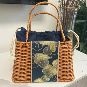 Woven basket bag detail showing imitation rattan texture, blue drawstring pouch, and gold cloud embroidery.