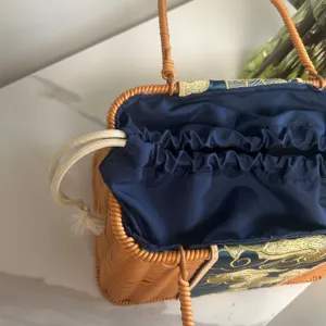 Handwoven rattan handbag with blue embroidered fabric lining and drawstring bag for daily.