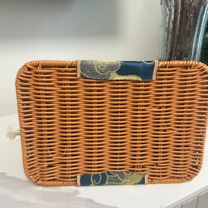 Handwoven imitation rattan trapezoid basket with chic embroidered trim for stylish daily use.