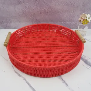 Close-up of round woven serving tray with wooden handles, ideal for desktop decor.