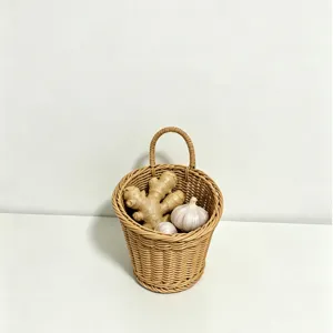 Close-up detail of the woven hanging storage basket holding fresh ginger and garlic in kitchen.