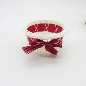 Hand-woven storage basket with red bow, cute desktop organizer for snacks and sundries.