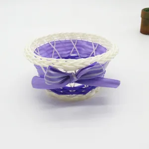 Hand-woven storage basket desktop sundries organizer with purple bow for home decor.