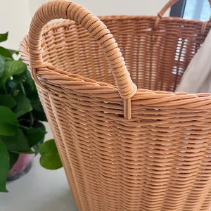 Close-up detail of imitation rattan woven storage basket laundry hamper with sturdy handles.