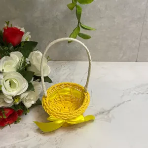 Mini woven flower basket with handle, yellow rattan pastoral style storage and floral decor.