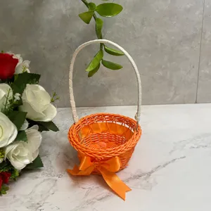 Mini woven flower basket with handle, orange rattan pastoral style desktop storage and decor.