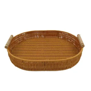 Oval imitation rattan woven storage tray with wood handles for living room desktop organization.