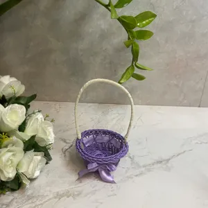 Mini woven flower basket with purple design, white handle and cute bow for home decor.