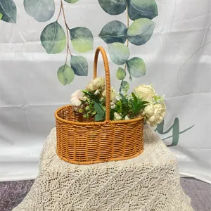 Panier de pique-nique ovale en rotin synthétique avec poignée, idéal pour le jardin et la maison.