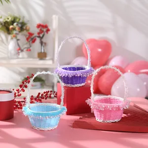Detailed view of colorful woven wedding flower baskets with delicate white lace trim handles.