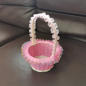 Detail view of pink woven flower basket featuring ruffled lace handle for wedding ceremonies.