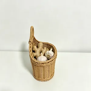 Woven hanging storage basket detail view showing rattan texture and ginger garlic inside.