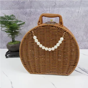 Round rattan wicker storage box with pearl handle, vintage cosmetic organizer for home decor.
