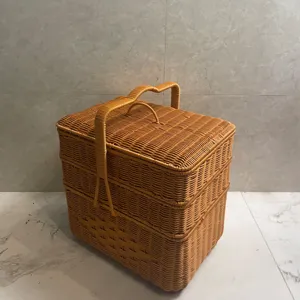 Detailed view of a brown three-layer woven storage basket with lid for outdoor picnics and home.
