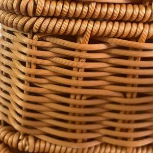 Close-up detail of handmade wicker storage basket, natural brown rattan weaving texture.