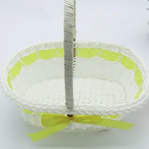 White wicker handheld flower basket with yellow ribbon bow, ideal for floral arrangement.