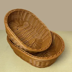 Detailed close up of oval imitation rattan storage baskets, stacked display for desktop use.