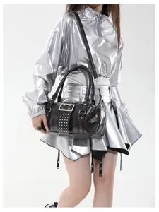 Detailopname van een zwarte punk handtas met studs, metalen gesp en handige schouderriem.