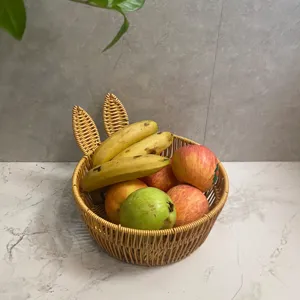 Rattan woven fruit basket with cute bunny ears, perfect for living room snack storage.
