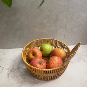 Detailed close-up shot of round imitation rattan fruit basket with fine weaving texture.