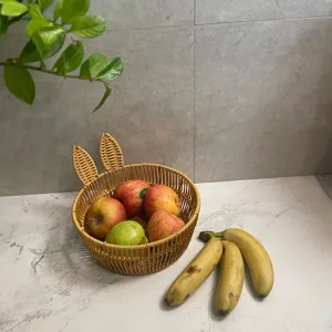 Rattan fruit basket with cute rabbit ears design for home living room storage tabletop.