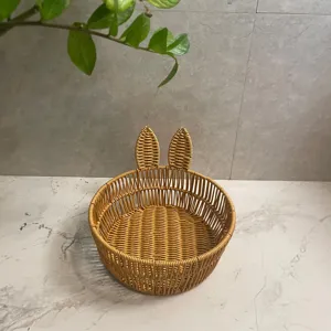 Imitation rattan storage basket with cute bunny ears design, perfect for home desktop organization.