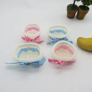 Mini handmade woven plastic flower baskets with colorful ribbon bows, perfect for party decor.