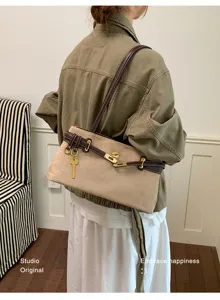 Chic retro suede shoulder bag for women, elegant commuter handbag with metal lock.