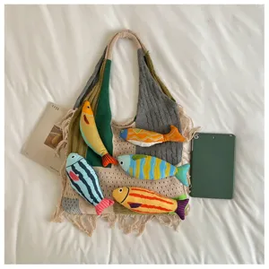 Detailed view of the knitted shoulder tote bag featuring cute colorful fish decorations and knit texture.