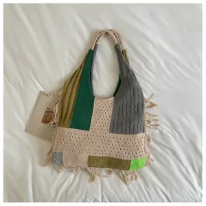 Stylish knitted patchwork tote bag with casual fringe design and comfortable shoulder straps.
