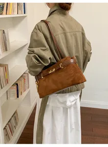 Stylish brown suede shoulder bag for women, classic design with metal lock and daily use.