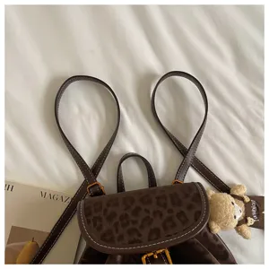 Korean style casual women backpack with leopard print flap and cute bear pendant, chic design.
