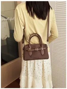Retro suede Boston handbag for women, chic commuting crossbody shoulder pillow bag detail view.