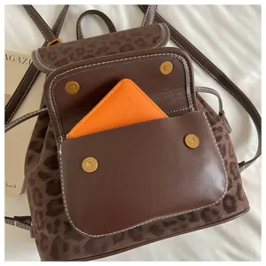 Brown leopard print backpack detail showing front pocket and metal clasp for women.