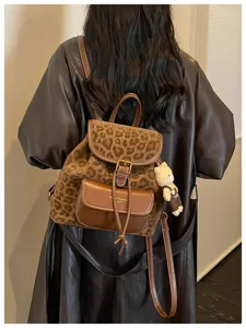 Korean style casual leopard print leather backpack for women with cute bear pendant accessory.