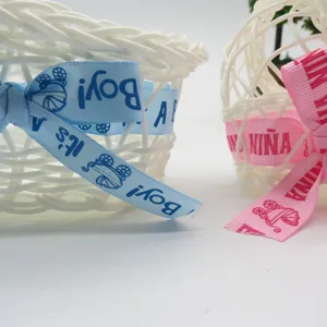 Plastic woven storage basket detail shot featuring blue baby shower ribbon decoration for party.