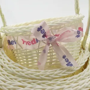 White imitation rattan storage basket nested set with cute pink bow ribbon for home organization.