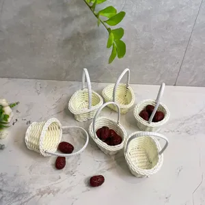 Mini white woven flower basket miniature rattan desktop storage container decoration detail view.