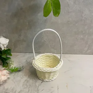 Detail shot of a white woven mini flower basket desktop ornament in a clean scene display.
