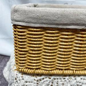 Close-up view of woven storage basket detail, showing textured rattan and fabric liner.