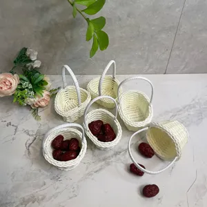 Mini woven rattan flower basket detail, cute white desktop decoration and floral display prop.