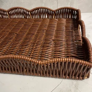 Detailed view of dark brown woven imitation rattan storage tray with scalloped edges for home.