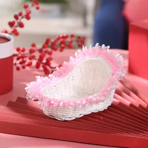 Detailed view of the pink lace woven heart-shaped basket, ideal for wedding flower girl use.