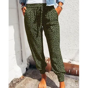 Detail shot of women's olive green leopard print casual pants with drawstring and cuffed hem.