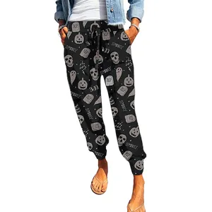 Detailed view of comfortable loose fit lounge pants with festive Halloween print and drawstring.