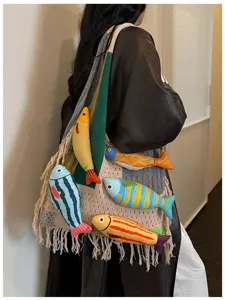 Detailed view of trendy knit tote bag with cute fish plush decorations and chic fringe design.