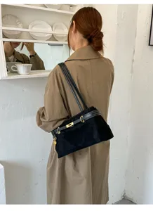Chic black suede shoulder bag for women, elegant daily commuter handbag with gold lock.