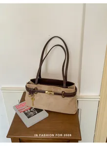 Vintage suede shoulder bag for women, stylish brown leather strap design, large capacity commuting handbag.