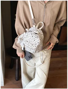 Vue détaillée du mini sac à dos style japonais à étoiles en tweed avec nœud mignon.